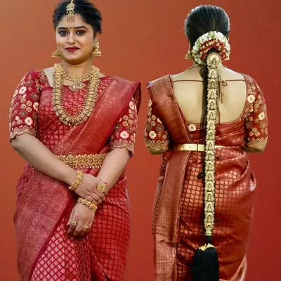 A complete and classic South Indian bridal look. The client is wearing a full rental set of temple jewellery with her red silk saree, including the traditional hair braid accessories.