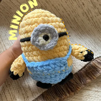 "Bello!" This chunky yarn Minion is ready for mischief and cuddles. We used premium, extra-soft yarn to make him incredibly huggable. His goggle and overalls are stitched with care, making him a durable and lovable friend for fans of all ages.