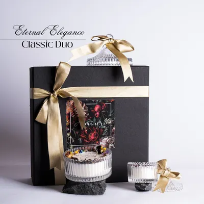 Our Eternal Elegance Classic Duo gift set. This showcases our premium black gift box with gold ribbon, containing two beautiful crystal jar candles, making for a truly luxurious gift.