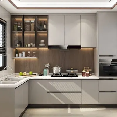 This L-shaped kitchen is a perfect example of modern efficiency. We used a two-tone scheme of grey and wood, with glass-front upper cabinets for display. The layout provides ample counter space and a clear, organized workflow from the sink to the stove.