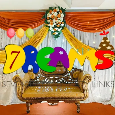 Here is a simple and elegant stage decoration suitable for home functions. I used bright yellow and orange drapes with fresh flower bouquets to create a colorful and festive backdrop.