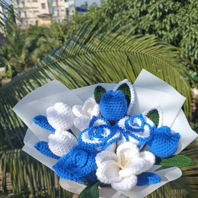 A custom blue and white bouquet, beautifully wrapped and ready for a special occasion.
