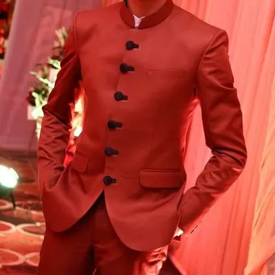 This is the kind of sharp, confident look I deliver. A client looking dapper in a custom-tailored vibrant red Jodhpuri suit, perfectly fitted for a wedding celebration.