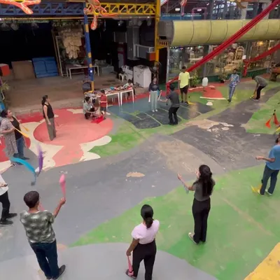 This is a typical scene from one of my workshops. You can see everyone spread out, practicing with different props like poi and juggling clubs at their own pace. It's a very hands on and relaxed learning environment.