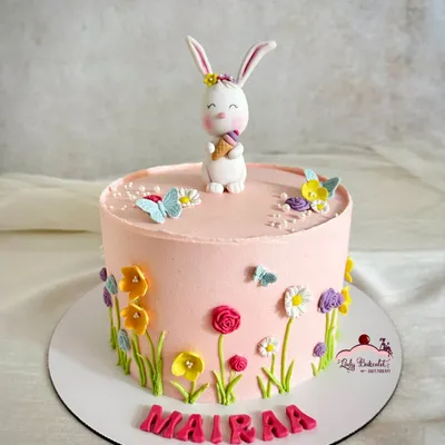 I designed this adorable Easter cake for a little one named Mairaa. The buttercream cake is decorated with hand-piped wildflowers, and the cute bunny topper holding an ice cream cone adds a playful touch.