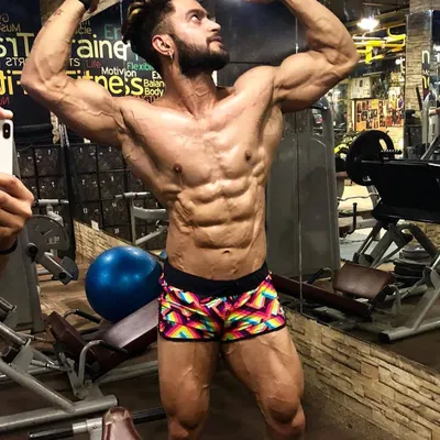 This classic bodybuilding pose shows the result of perseverance. A shredded physique with defined abs and full muscle bellies is achieved through hard training and a smarter diet.