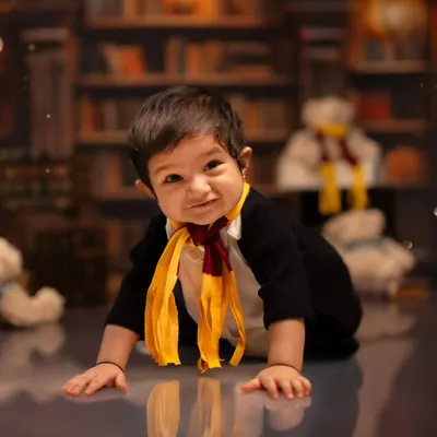 A playful crawl through our Hogwarts-inspired library set. This image from a Harry Potter themed toddler shoot captures the magic and movement of your little one exploring the set.