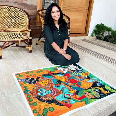 Here I am with a completed Radha Krishna mural-style painting. I love working on large canvases like this, filling them with the bright, bold colors and intricate details that are characteristic of Kerala's traditional art.
