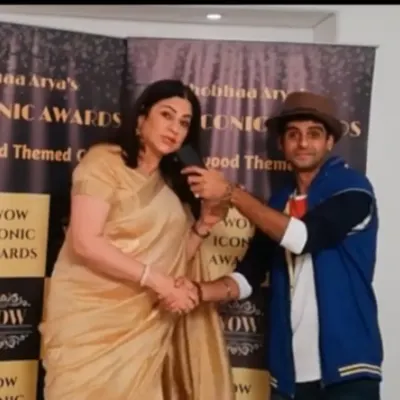 Shaking hands with actress Kunicka Sadanand during a red carpet interview for the WOW Iconic Awards. I maintain a professional and respectful demeanor while hosting.