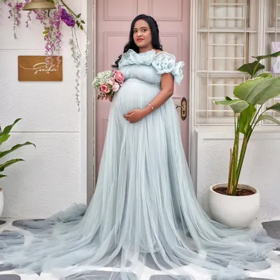 Our iconic Elsa gown in ice blue, featuring a full tulle skirt and organza flower details. It’s perfect for creating a magical look, especially in our Santorini-themed studio setup.