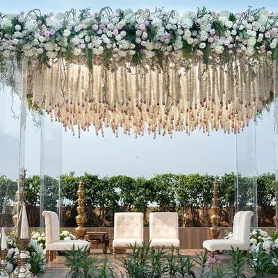 A full view of our floating floral mandap at Jade Gardens, designed to look like a cloud of flowers suspended on clear acrylic pillars. This creates an unobstructed view and a sense of modern grandeur for the wedding ceremony.