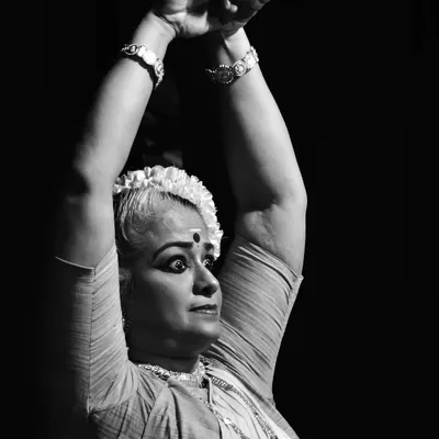 A powerful moment of expression captured in black and white during a 'sevakkalam' performance at Sreeramaswami temple. The intensity in the eyes and posture conveys the deep narrative of the dance.