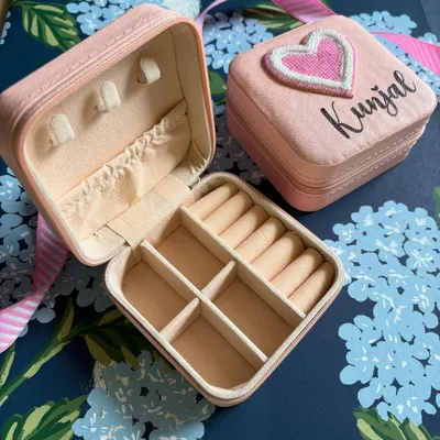 Keep your precious trinkets safe in our personalised jewellery boxes. This pink box is customised with a name and a cute heart patch, and has compartments for all your baubles.