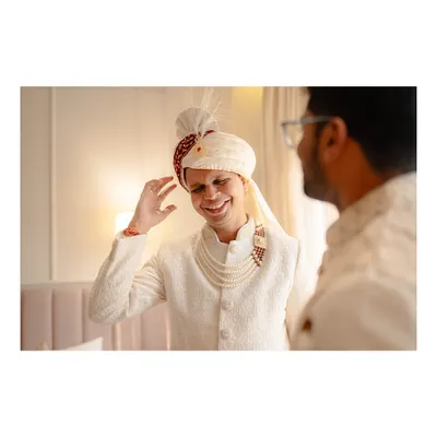The groom, Abhishek, shares a laugh while getting ready for his Bengali wedding ceremony.
