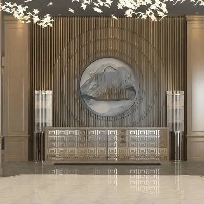 We designed this grand lobby to make an unforgettable first impression. The space is defined by a custom circular art piece set against a textured, fluted wall, creating a stunning focal point. Paired with a modern credenza and dramatic overhead lighting, this entrance communicates pure luxury and sophistication.