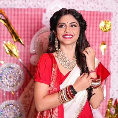 A beautiful look created for Bengali New Year. I styled actress Megha Chakraborty in a traditional red and white saree, with soft makeup focusing on a radiant smile and bright red lip, complemented by a half updo hairstyle.