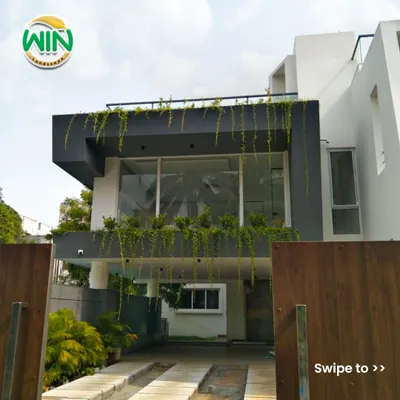 My work extends to large-scale commercial projects. For this building, I designed and installed cascading greenery that flows down the facade, softening the modern architecture and creating a memorable first impression for visitors.