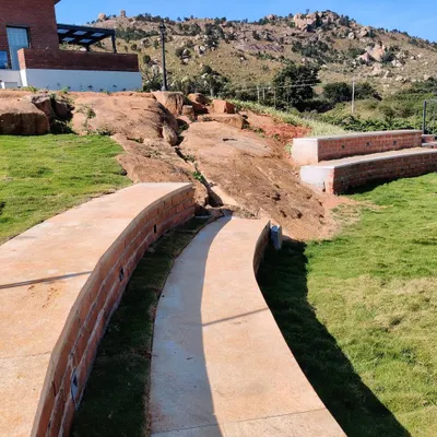 We transformed a natural rock formation at our Nandi Hills project into an informal amphitheater. This is a perfect example of our site specific design approach, using existing contours and features to create unique, functional outdoor spaces.
