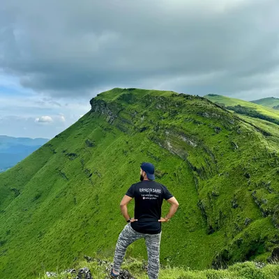 Taking in the stunning ridge-line view from Z-point in Kemmangundi. This is a highlight of my "Explore Chikmagalur" itinerary, perfect for groups who love panoramic mountain vistas.