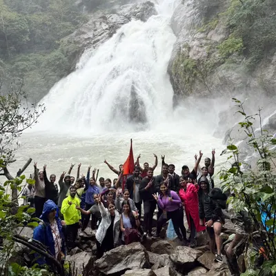 A wide-angle view of our group celebrating at the base of the mighty Dudhsagar Falls. The sheer volume of water during monsoon is a sight to behold.