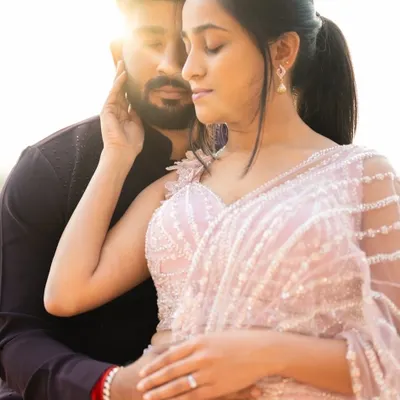 A romantic close up from a pre wedding shoot. The bride to be wears a custom lavender half saree with delicate pearl and beadwork, a soft and dreamy choice for capturing their love story.