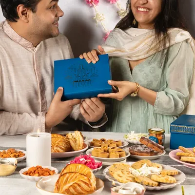 The perfect Rakhi or Bhai Dooj moment, sharing a beautifully designed Meetha Maska Diwali gift box. Our hampers are made for creating and sharing sweet memories with your loved ones.
