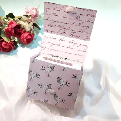 A vintage-themed mini scrapbook in its gift box.