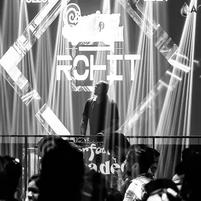 A dramatic black and white shot of me at the console at Sugar Factory, focused on the mix. The lighting and stage setup here are incredible.