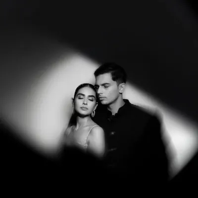 When colors fade, emotions take the spotlight. This black and white portrait uses a single sliver of light to create a dramatic, intimate, and timeless image of the couple's connection.