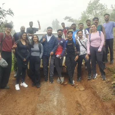 Our group with the 4x4 jeep that takes us on a thrilling off-road journey to the Kodachadri peak. It's a key part of the adventure.