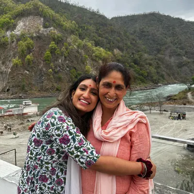 A precious moment with my mother at the Phool Chatti Ashram in Rishikesh. This place is pure tranquility. My own yoga and meditation practice, especially in such serene surroundings, deeply influences the peaceful energy I share in my classes.
