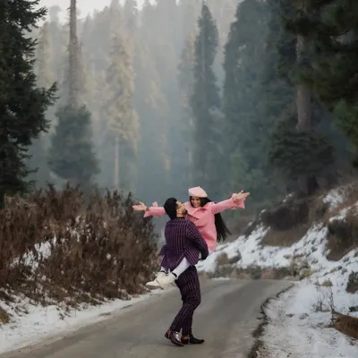 A moment of pure joy, lifted up against the vastness of the snow-covered pines in Kashmir. We encourage playful, spontaneous interactions that result in photos filled with life and energy, perfect for an adventurous pre-wedding shoot.