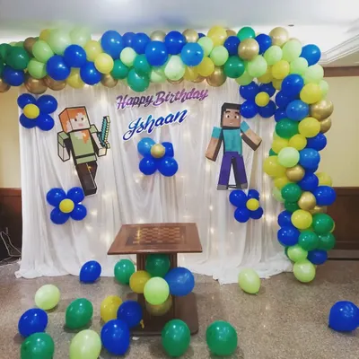 A fantastic Minecraft-themed birthday backdrop. I used a combination of a balloon arch in the game's signature colors and character cutouts to create an immersive world for the birthday boy and his friends.