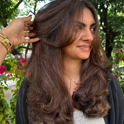 This is my signature layered cut. Notice how the face-framing pieces soften her features. The layers are designed to create movement and are easy to style at home.