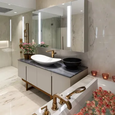 A master bathroom designed as a spa-like retreat. The bathtub is filled with rose petals, and the vanity from our Koko collection features elegant lines and high-quality materials. We believe every corner of a home should be treated with intention and care.