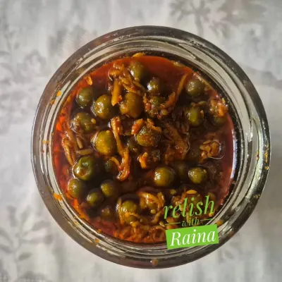 This is a jar of my authentic Rajasthani Kair Pickle. Kair are desert berries that I source directly from Rajasthan during the summer. They are soaked in buttermilk to soften and develop a sour taste before being pickled with grated raw mango and spices. It's a rare flavour that brings the taste of Rajasthan to your plate.