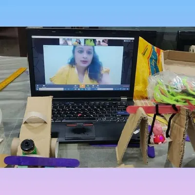 A snapshot of our online STEM class where we built a miniature playground. You can see the final creations, including a see-saw, slide, and swing, all made from simple cardboard and craft supplies.