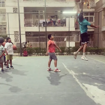 I love showing the kids what's possible. Here I am going up for a dunk while they watch. It inspires them to work hard and aim high.