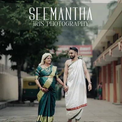 A happy couple dressed in traditional attire for their Seemantha ceremony, walking hand-in-hand down a street. This candid shot captures the joy and connection between them during this special celebration.