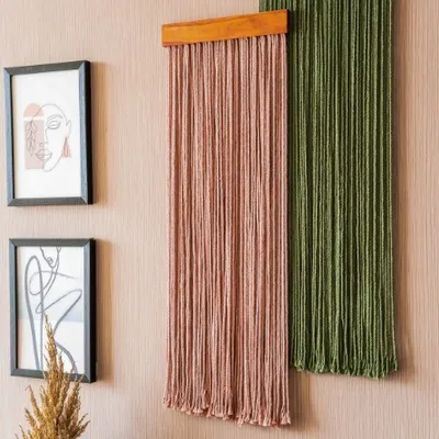This pairing of dusty pink and olive green hangings shows how effectively our pieces can be grouped. The clean, vertical lines add height and texture to the wall, complementing the surrounding framed art for a cohesive and stylish look.