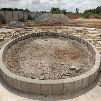 The first step is laying the foundation. Here, you can see the custom circular planter bed, a hardscape feature, built on the prepared site before any soil or plants are added.