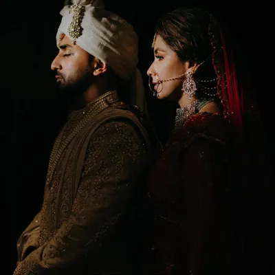 An artistic, moody portrait of the couple back-to-back. This dramatic lighting and composition showcases our creative approach to couple photography.