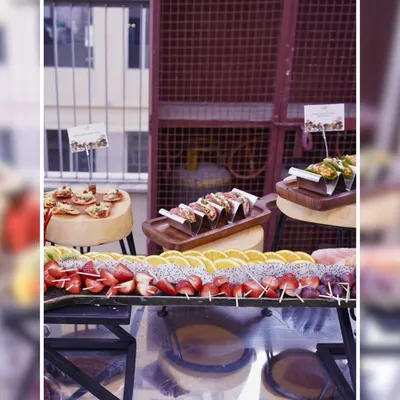 A full view of our appetizer station at an outdoor event. This setup includes fresh fruit skewers, mini tacos, and other bite-sized snacks, all beautifully arranged and ready for guests.