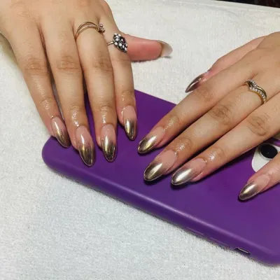 Go for gold with these stunning, full-coverage metallic gold chrome nails, shaped into a sharp almond point for a truly liquid-metal look.