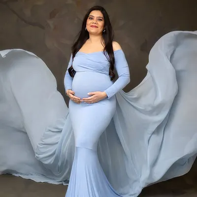 A vision in blue. The flowing fabric of this gown adds drama and movement, creating a stunning silhouette against the classic studio backdrop. This is a favorite from my client wardrobe.