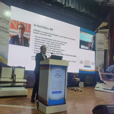 This is a shot of me presenting my credentials and areas of interest before my talk on laser hair removal. My focus is always on clinical dermatology and evidence-based aesthetic procedures.
