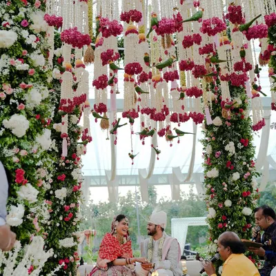 A fairytale moment under a canopy of thousands of flowers. This mandap was designed to feel like a secret garden, creating an intimate and romantic setting for the couple's vows.