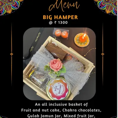 My Big Hamper for Diwali, an all-inclusive basket with a Fruit and Nut Cake, Chakra chocolates, a Gulab Jamun jar, and non-edible gifts like Laddoo candles and a wooden pen stand.