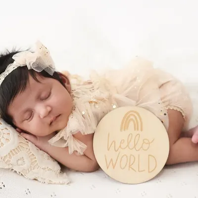 Hello, world. This is one of my favorite ways to announce your baby's arrival. The simple "hello world" plaque next to your peacefully sleeping newborn creates a beautiful and classic birth announcement photo.