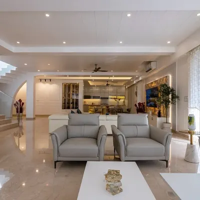 This open-plan living area from the Diamond District project showcases a seamless flow between spaces. I used a consistent palette of soft neutrals, polished marble floors, and comfortable, modern furniture to create an atmosphere of understated luxury.